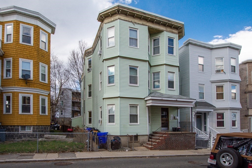 15 Hecla Street Boston, MA 02122 - Photo 29 of 33 a front view of a residential apartment building with a yard