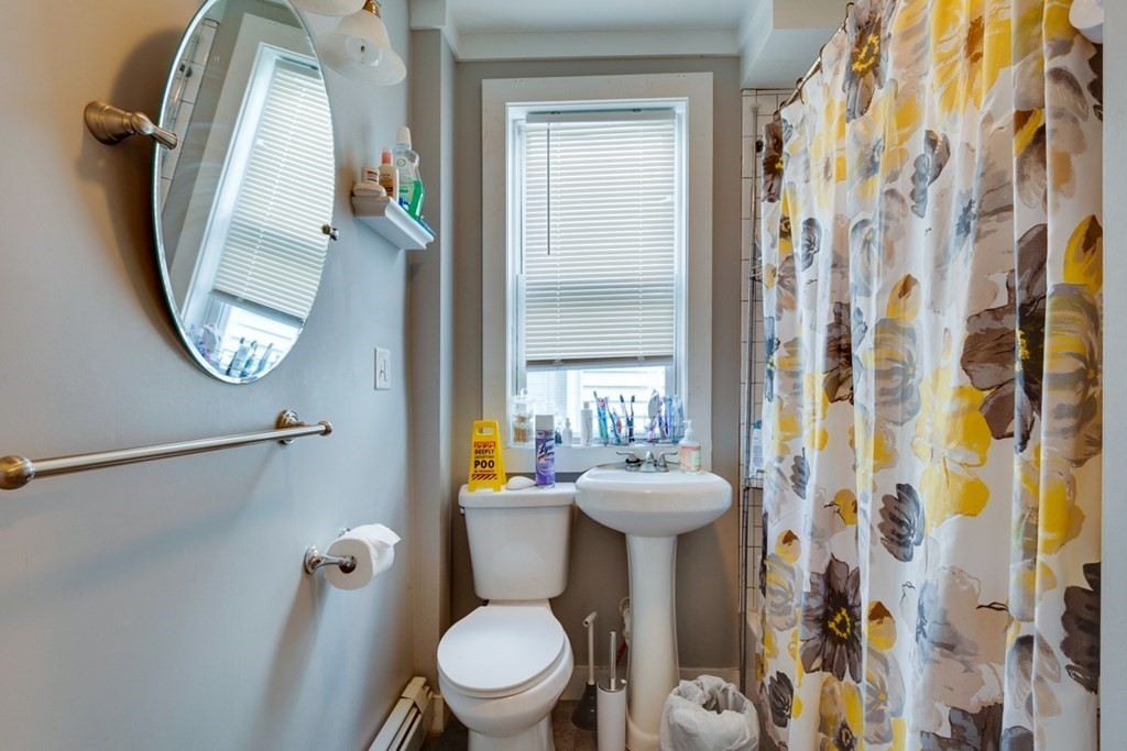 15 Hecla Street Boston, MA 02122 - Photo 8 of 33 a bathroom with a toilet sink and mirror