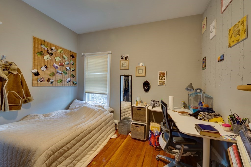 15 Hecla Street Boston, MA 02122 - Photo 9 of 33 a bedroom with a bed and wooden floor