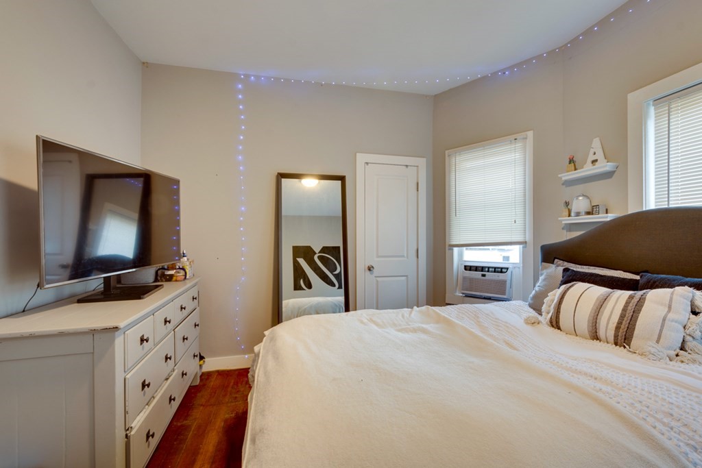 15 Hecla Street Boston, MA 02122 - Photo 10 of 33 a bedroom with a bed and a flat tv screen on dresser