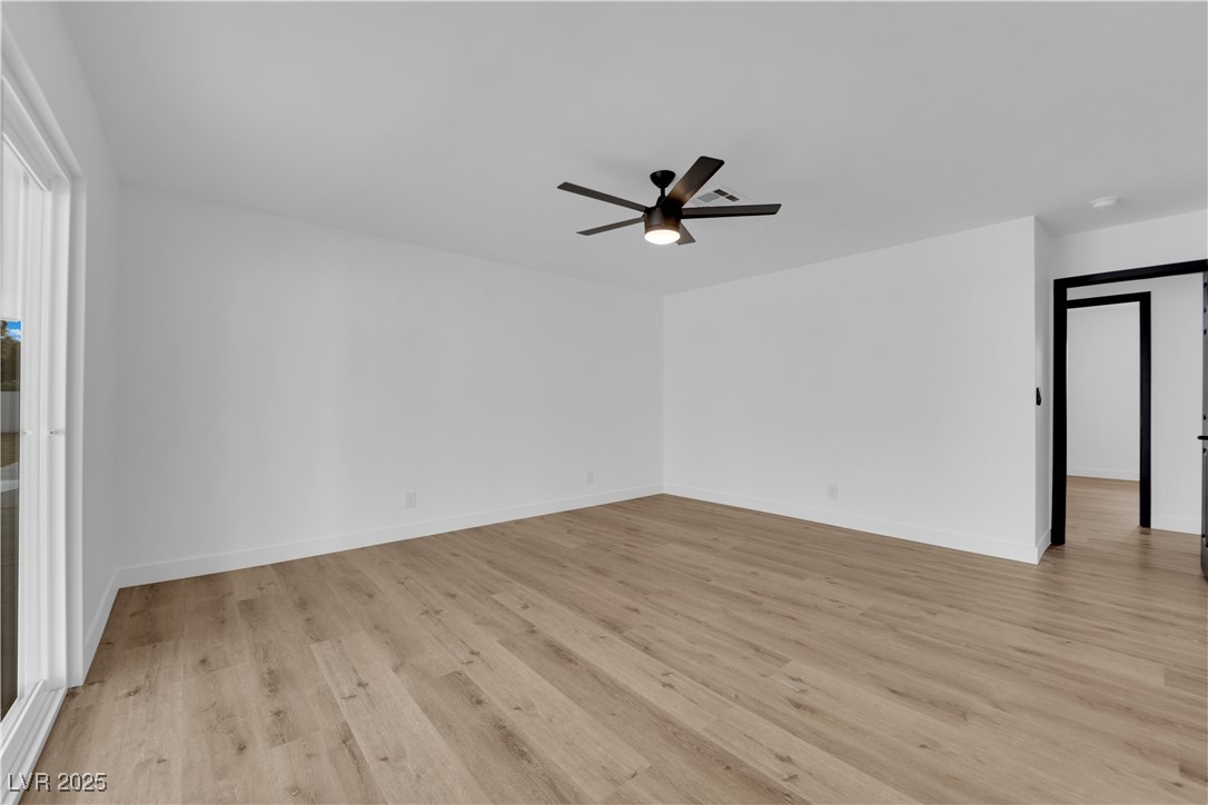 3228 Robin Circle Las Vegas, NV 89121 - Photo 36 of 45 Empty room featuring baseboards, light wood-type f