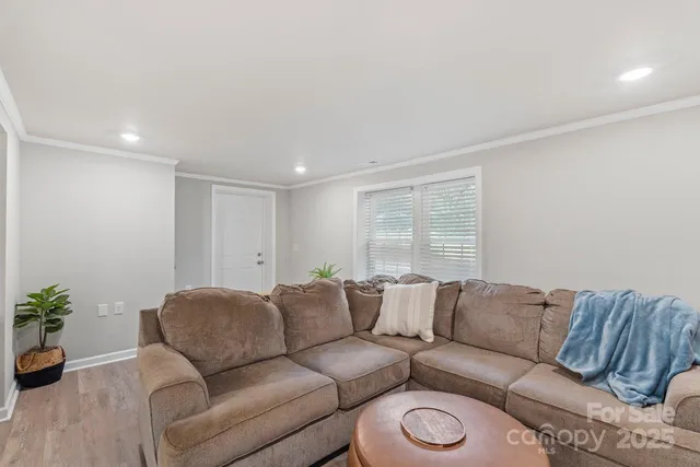 a living room with furniture a couch and with potted plants
