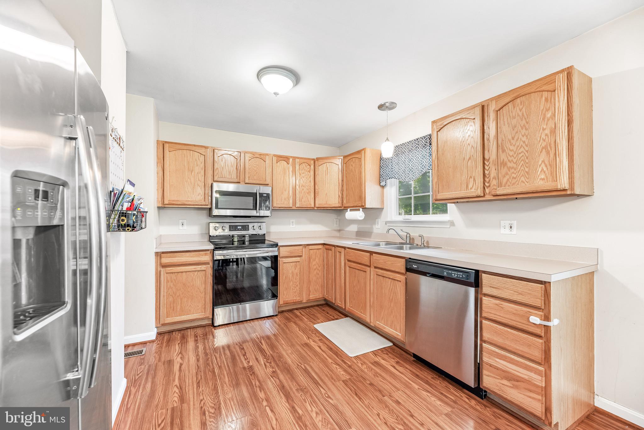 11156 Rawhide Road Lusby, MD 20657 - Photo 5 of 33 a kitchen with stainless steel appliances granite countertop a stove a sink dishwasher and a refrigerator
