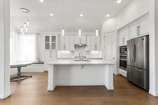 a kitchen with stainless steel appliances granite countertop a sink stove and refrigerator