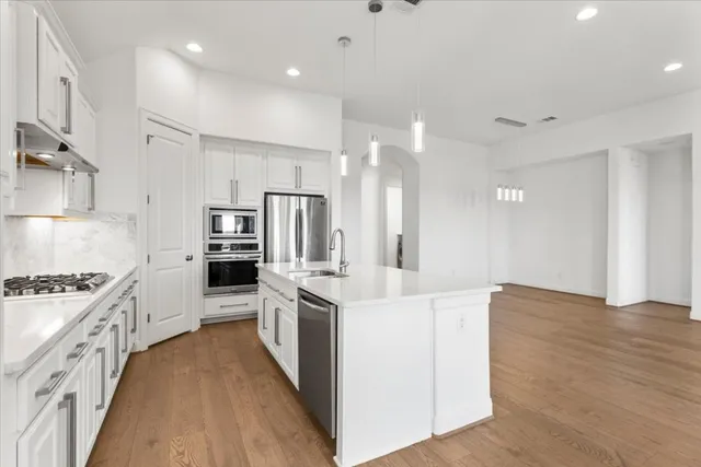 a spacious bathroom with a double vanity sink a mirror and a bathtub