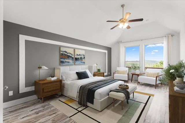 a bedroom with a large bed and a chandelier