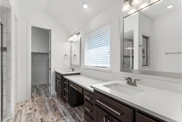 a bathroom with double sink and a mirror