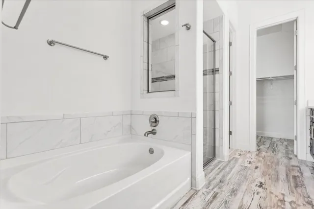 a bathroom with a bathtub and shower