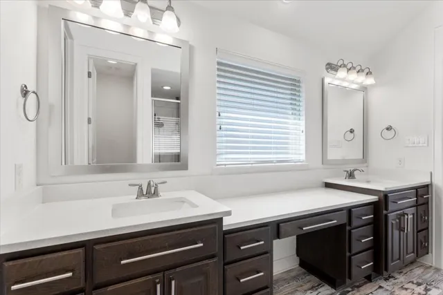 a bathroom with a sink double vanity and a mirror
