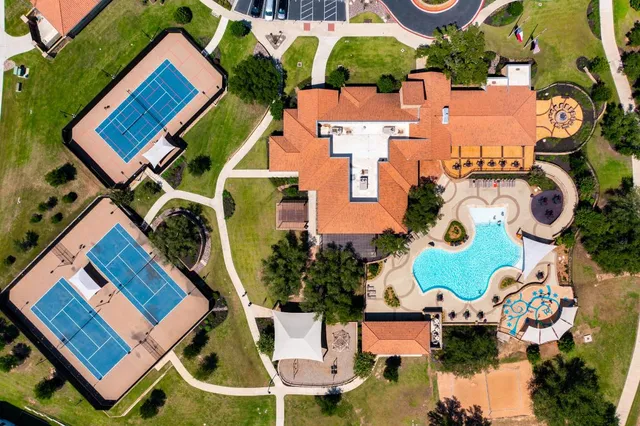 an aerial view of a house with swimming pool and outdoor space