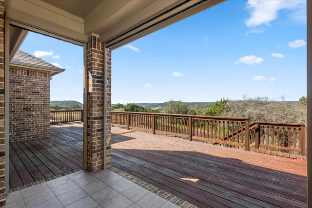 a view of balcony with wooden floor and fence