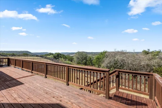 a view of a balcony with wooden floor and city view