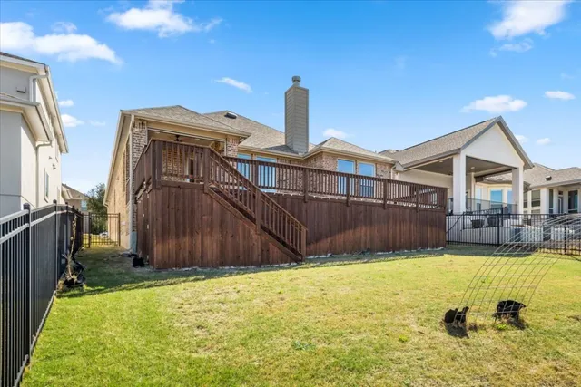 a balcony with wooden floor and fence
