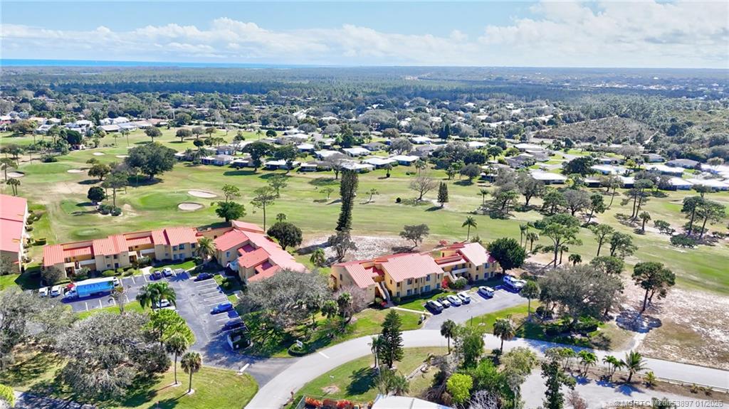 5303 Southeast Miles Grant Road, Unit L101 Stuart, FL 34997 - Photo 13 of 54 an aerial view of residential houses with outdoor space and seating