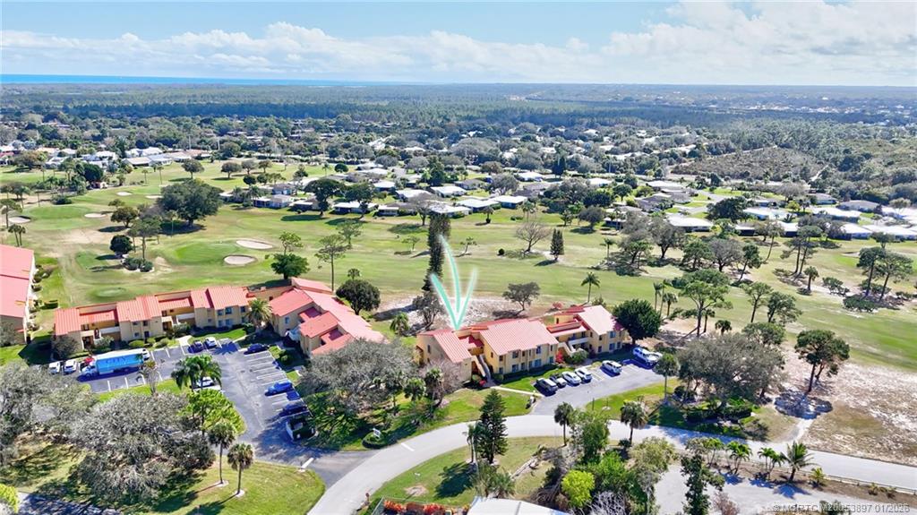 5303 Southeast Miles Grant Road, Unit L101 Stuart, FL 34997 - Photo 16 of 54 an aerial view of a houses with a lake