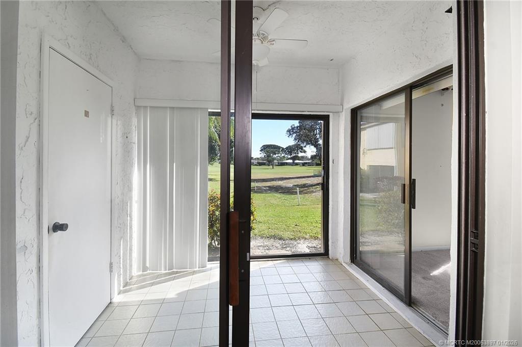 5303 Southeast Miles Grant Road, Unit L101 Stuart, FL 34997 - Photo 20 of 54 a bathroom with a glass shower door and a window