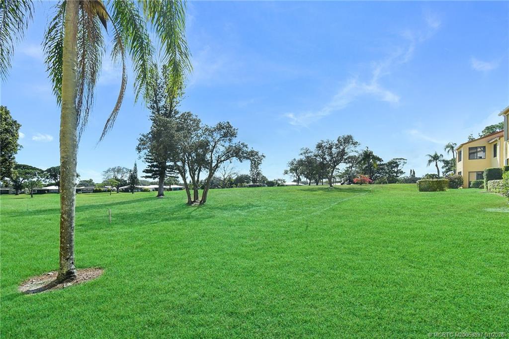 5303 Southeast Miles Grant Road, Unit L101 Stuart, FL 34997 - Photo 29 of 54 a view of a park with large trees