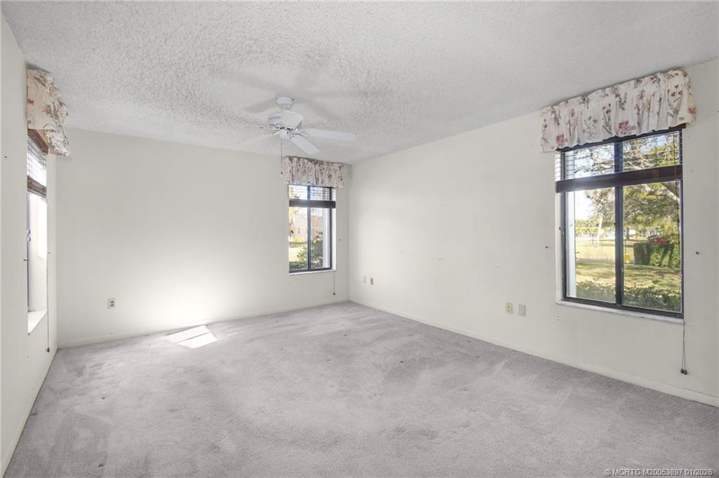 5303 Southeast Miles Grant Road, Unit L101 Stuart, FL 34997 - Photo 4 of 54 wooden floor in an empty room with a window