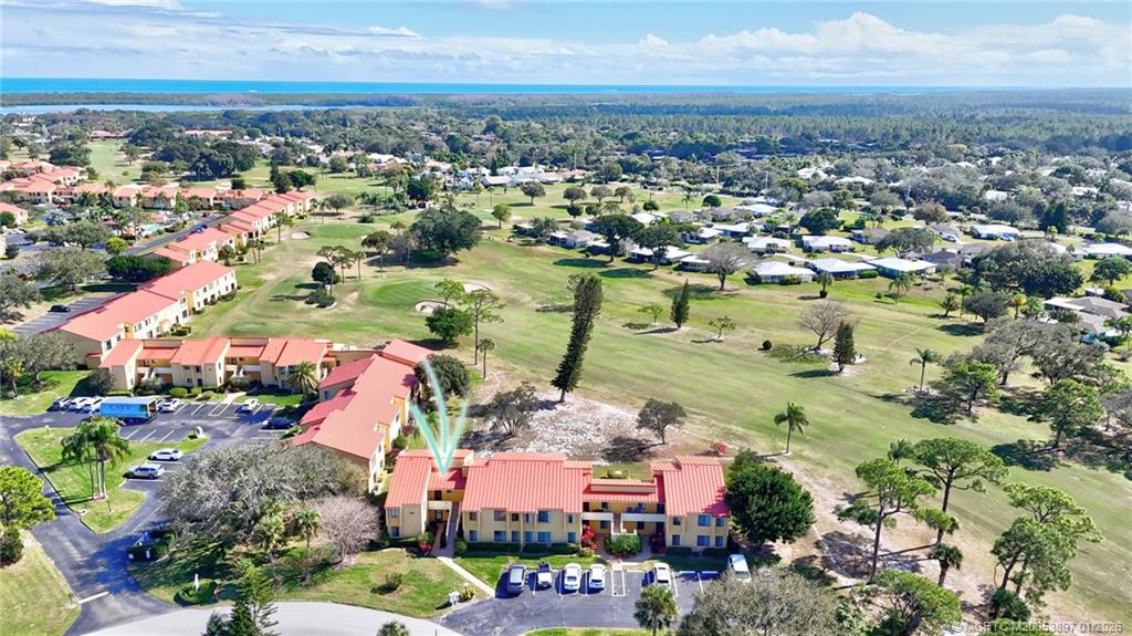 5303 Southeast Miles Grant Road, Unit L101 Stuart, FL 34997 - Photo 45 of 54 an aerial view of residential houses with outdoor space
