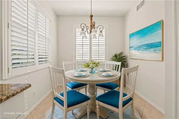 a view of a dining room with furniture and window