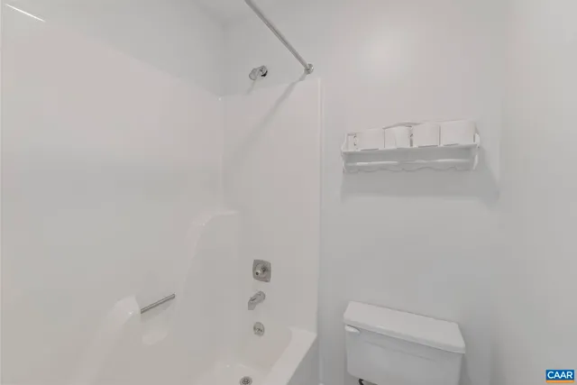 a bathroom with a toilet and a bathtub