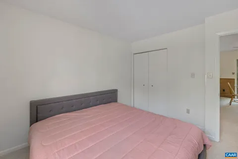 a bedroom with a bed and a view of bathroom