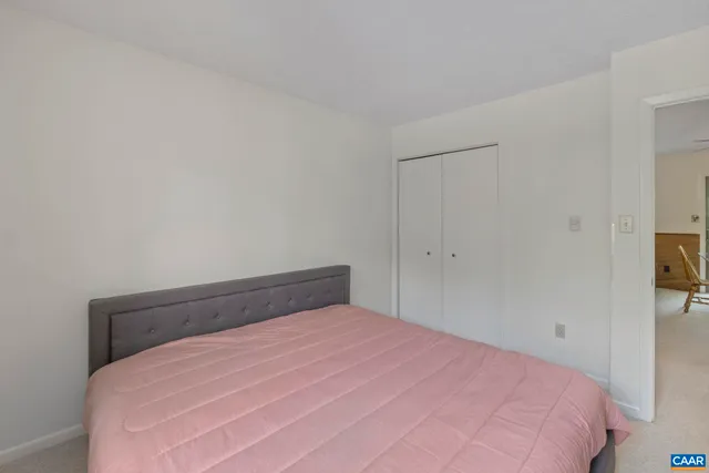 a bedroom with a bed and a view of bathroom