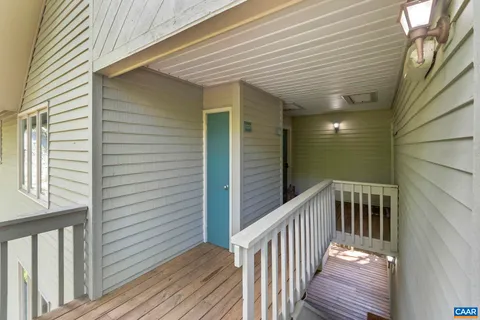 a view of a balcony with wooden floor
