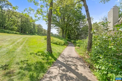 a yard with trees in the background