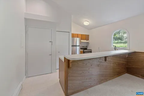 a view with kitchen island with furniture and window