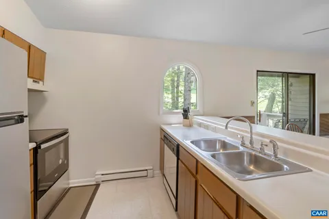 a bathroom with a granite countertop sink a mirror and a window