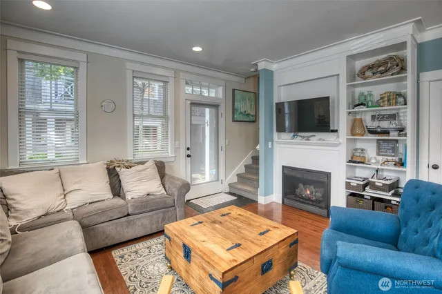 a living room with furniture a flat screen tv and a fireplace