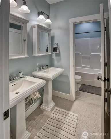 a spacious bathroom with a sink and a mirror