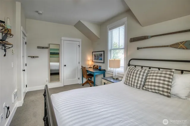 a bedroom with a bed and a chair