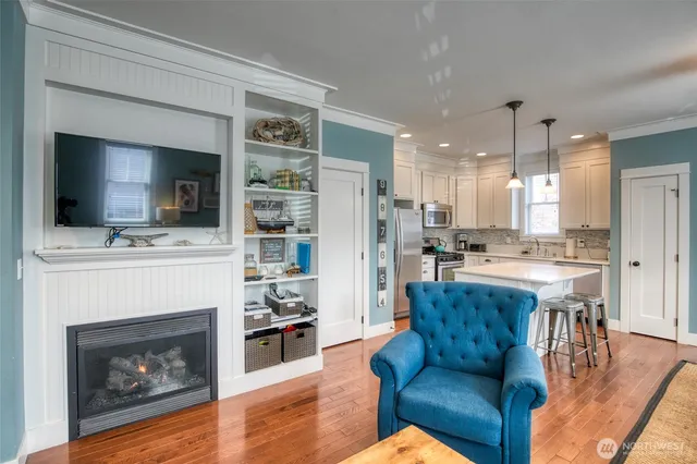 a living room with furniture a flat screen tv and a fireplace