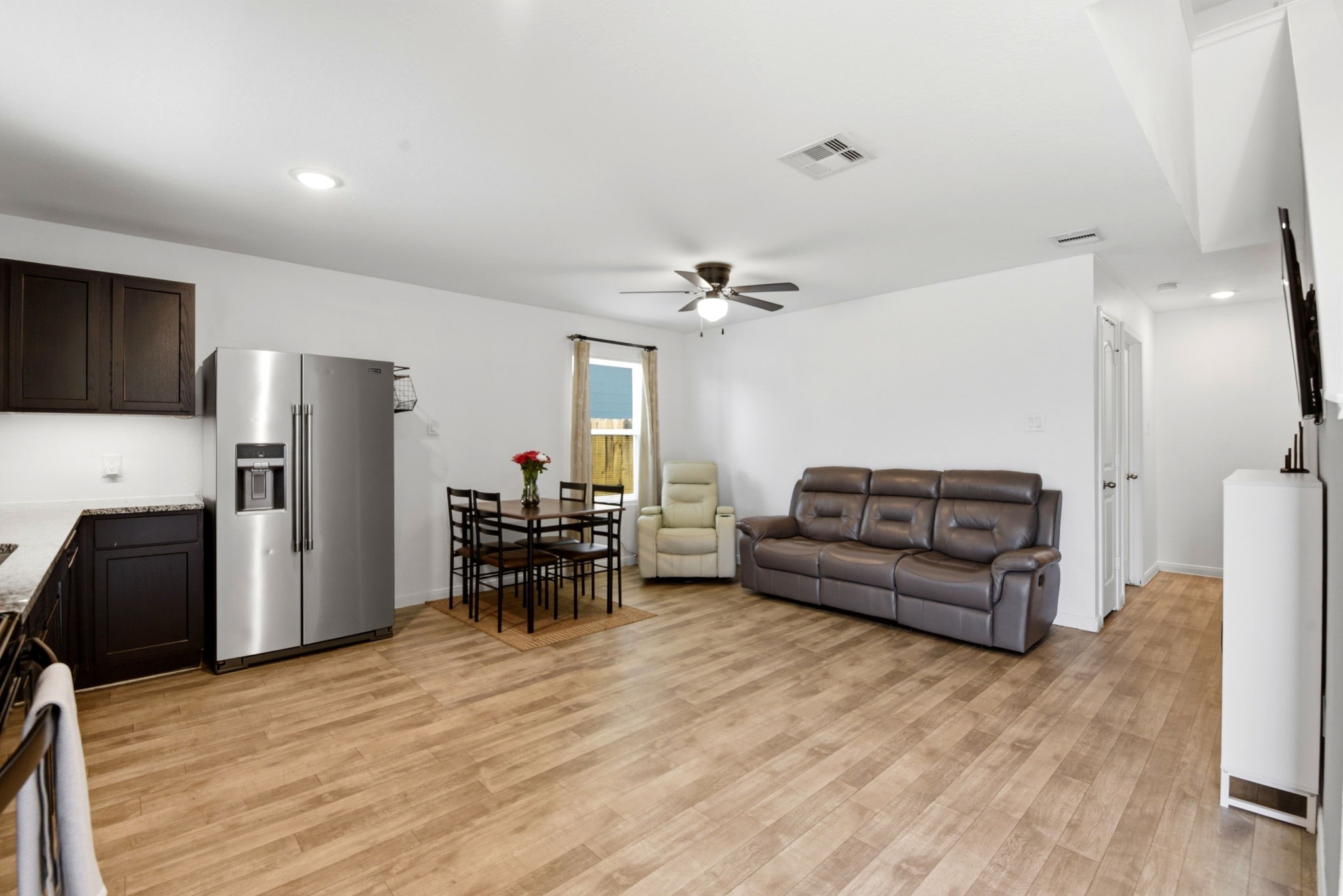 9819 Emerald Stone Way Conroe, TX 77306 - Photo 7 of 38 a living room with furniture and a wooden floor