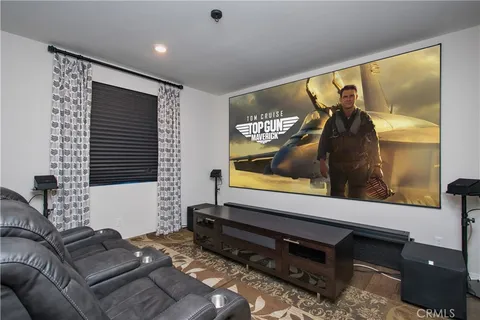 a kitchen with stainless steel appliances granite countertop a stove a sink a microwave a refrigerator with a dining table and chairs