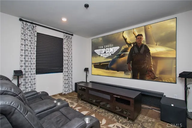 a kitchen with stainless steel appliances granite countertop a stove a sink a microwave a refrigerator with a dining table and chairs