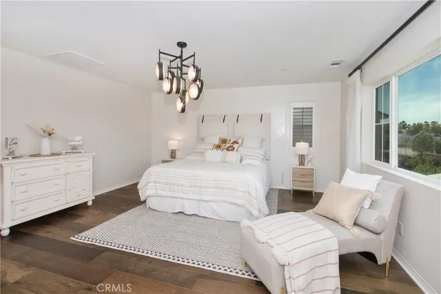 a bedroom with a large bed and a window