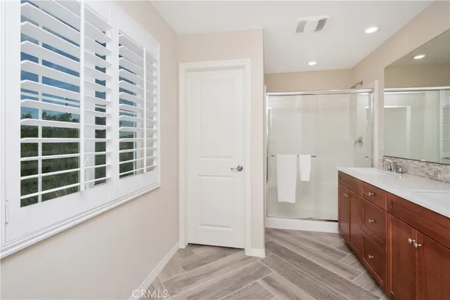 a bedroom with a white bed and dresser