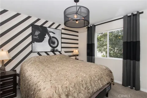 a bed sitting in a bedroom next to a window