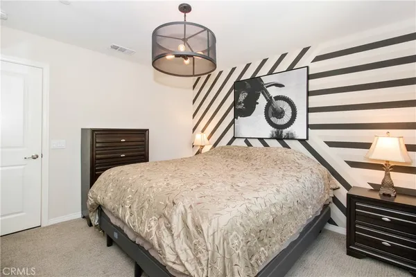 a bed sitting in a bedroom next to a window