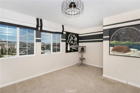 a bedroom with a bed and dresser with closet