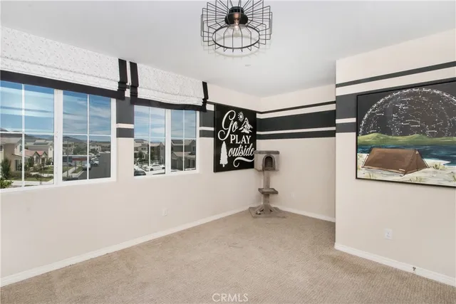 a bedroom with a bed and dresser with closet