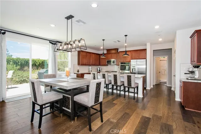 a view of a dining room with furniture wooden floor and chandelier
