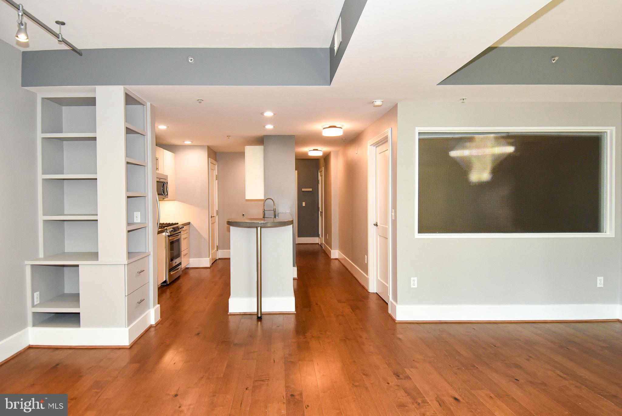 2100 11th Street Northwest, Unit G02 Washington, DC 20001 - Photo 15 of 36 a view of a big room with wooden floor and windows
