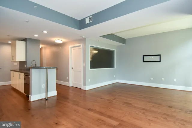 a kitchen with kitchen island a sink a stove and a refrigerator