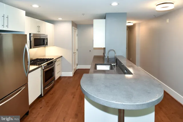 a kitchen with a refrigerator a stove and a sink