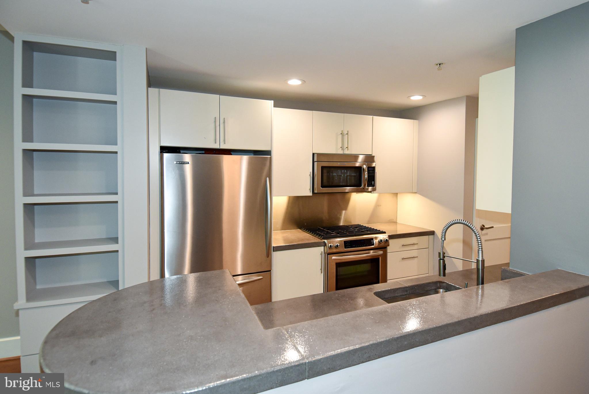 2100 11th Street Northwest, Unit G02 Washington, DC 20001 - Photo 18 of 36 a kitchen with a refrigerator a stove and a sink