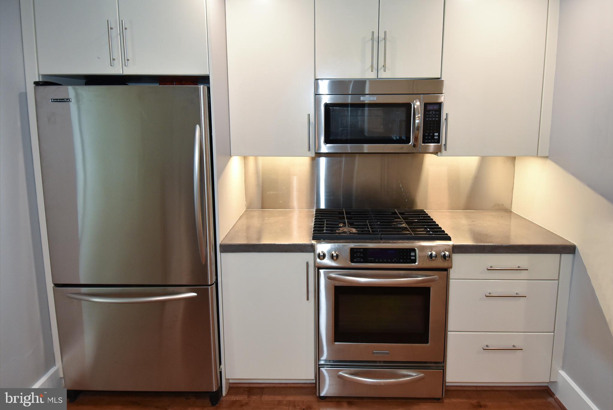 2100 11th Street Northwest, Unit G02 Washington, DC 20001 - Photo 19 of 36 a kitchen with a stove and a microwave